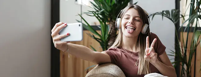 Chica sonriendo a un móvil porque tiene la mejor tarifa fibra-movil-Euskaltel